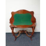 A Victorian mahogany turnover topped card table with shaped under stretches