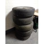 Four alloy wheels and five further car wheels