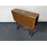 An Edwardian inlaid mahogany Sutherland table