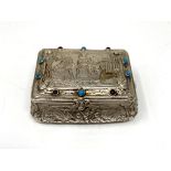 A continental white metal snuff box with cabochon decorated lid