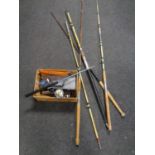 A quantity of fishing rods and a box of reels etc