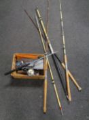 A quantity of fishing rods and a box of reels etc