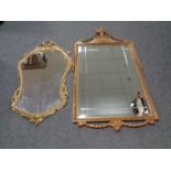 A gilt ornate mirror together with a further metal framed mirror and a pediment