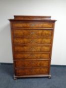A 19th century walnut seven drawer narrow chest