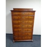 A 19th century walnut seven drawer narrow chest