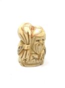 A carved Chinese bone netsuke - Village elder carrying sack