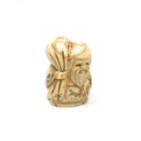 A carved Chinese bone netsuke - Village elder carrying sack