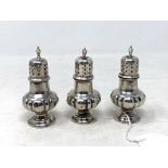 Three small silver pepper pots, weight 73.