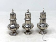 Three small silver pepper pots, weight 73.
