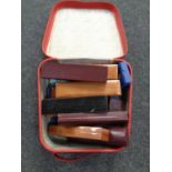 A leather case containing a quantity of empty jewellery boxes