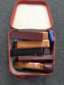 A leather case containing a quantity of empty jewellery boxes