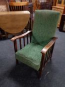 An Edwardian oak framed fireside chair