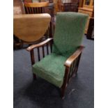 An Edwardian oak framed fireside chair