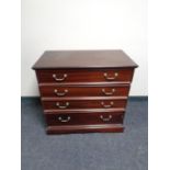 A reproduction mahogany four drawer chest