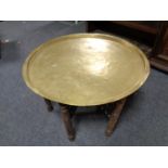 A brass topped folding carved table