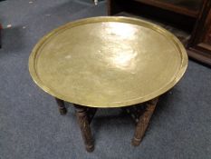 A brass topped folding carved table