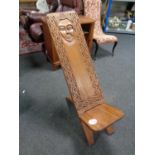 A carved African folding seat