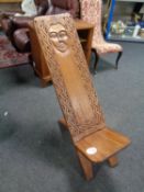 A carved African folding seat