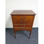 An Edwardian inlaid mahogany four drawer music chest