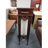 A reproduction mahogany plant stand