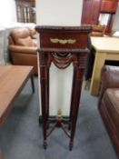 A reproduction mahogany plant stand