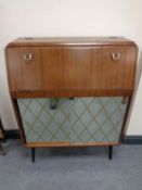 A mid century fall-front drinks cabinet