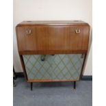 A mid century fall-front drinks cabinet