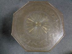 A brass topped plant table on mahogany base