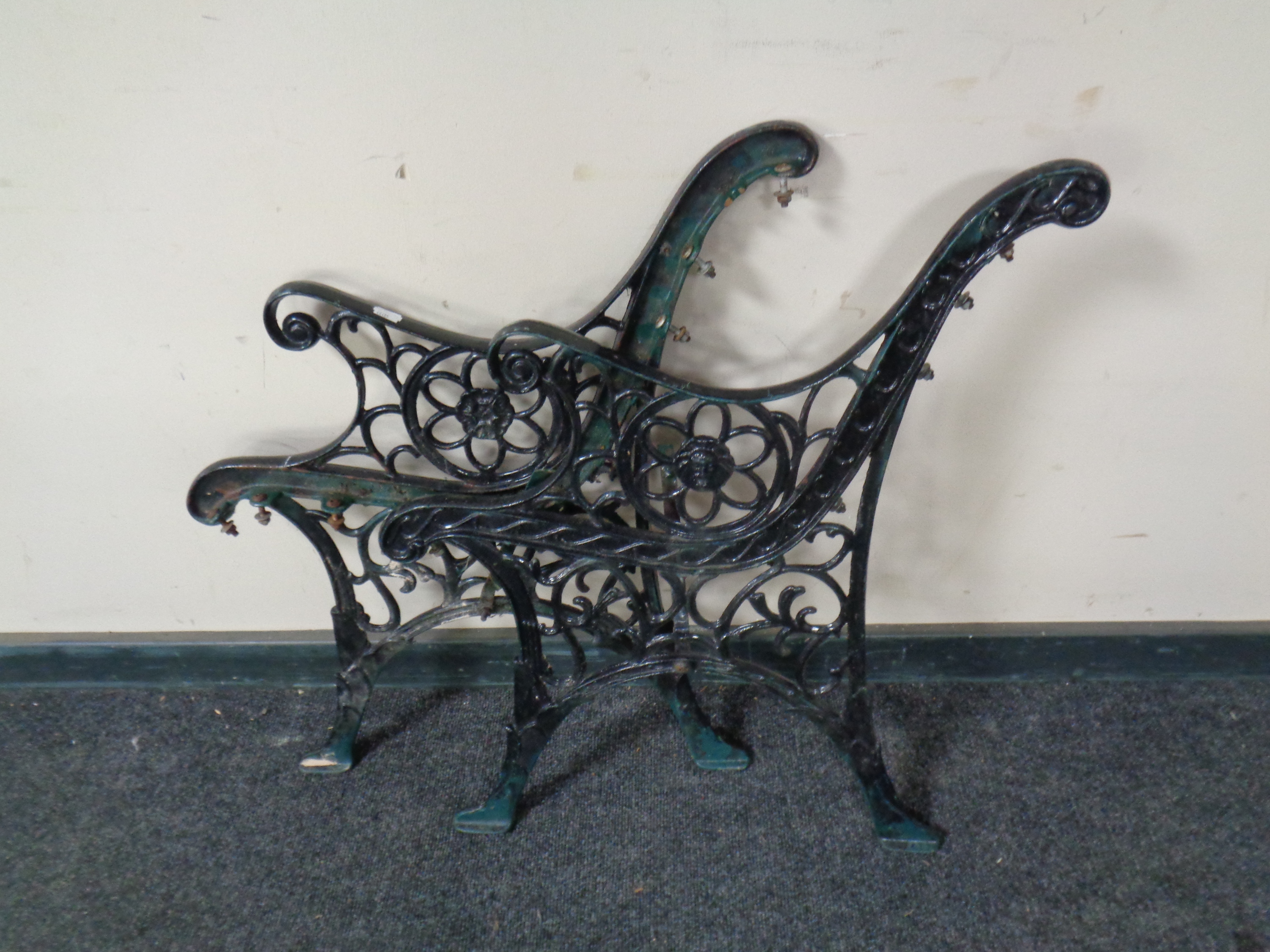 A pair of metal bench ends