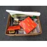 A box containing a collection of model railway accessories including buildings,