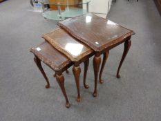 A nest of mahogany tables