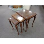 A nest of mahogany tables