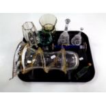 A tray containing antique and later glassware to include green glass bottle, hand bells,