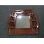 A hardwood mirror in an ornate frame
