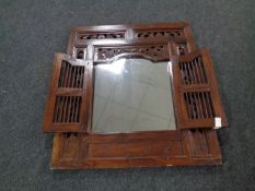 A hardwood mirror in an ornate frame