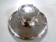 A silver inkwell,