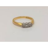 An 18ct gold three stone diamond ring, stated total diamond weight .