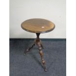 A small antique tripod table with glass ball feet