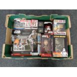 A box containing a collection of boxed Star Wars bobble head figures, Star Wars six in one game set,