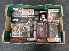 A box containing a collection of boxed Star Wars bobble head figures, Star Wars six in one game set,