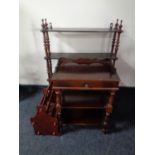 A walnut low coffee table together with a magazine rack and a telephone table