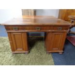 An Edwardian oak pedestal desk