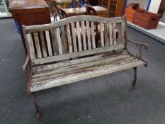 A wooden slatted metal framed garden bench