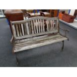 A wooden slatted metal framed garden bench