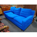A contemporary three seater settee in blue corded fabric