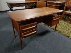 A mid century teak desk CONDITION REPORT: Missing a drawer handle.