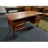 A mid century teak desk CONDITION REPORT: Missing a drawer handle.