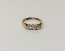 An 18ct gold three stone diamond ring, size K CONDITION REPORT: 2.