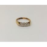 An 18ct gold three stone diamond ring, size K CONDITION REPORT: 2.