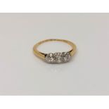 An antique 18ct gold three stone diamond ring, approx. 0.